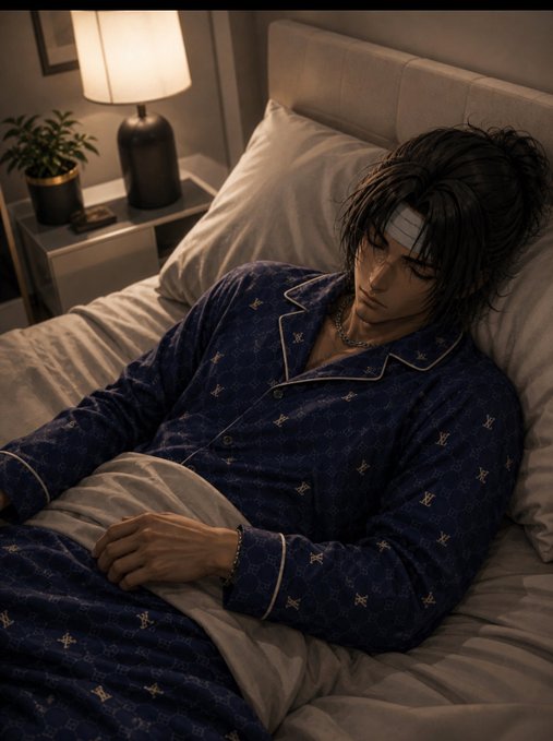 An anime-style illustration shows a dark-haired male character sleeping in bed wearing dark blue pajamas with a pattern, with a lamp glowing softly on the nightstand beside him.