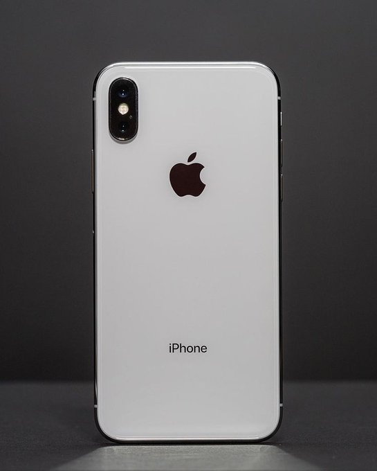 A pristine white iPhone with its signature Apple logo and the text "iPhone" displayed on the back, standing upright against a dark background. The image pairs with "web3 did" to humorously reference Apple's sleek hardware aesthetic as a contrast to web3's often chaotic and experimental digital landscape.