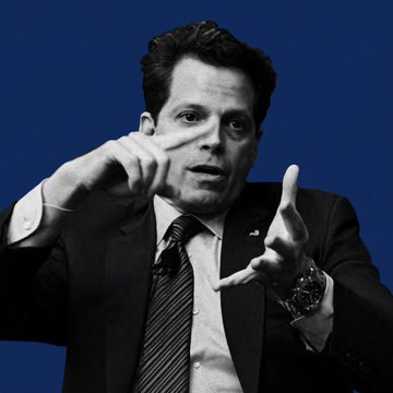 A man in a suit gestures with his hands while speaking against a blue background, matching the image of Anthony Scaramucci discussing Bitcoin's $100,000 milestone and blockchain's role in agentic AI at the SALT Conference.