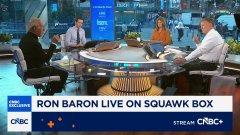A CNBC television broadcast shows four people seated around a round studio desk, with a lower-third graphic reading 'RON BARON LIVE ON SQUAWK BOX' and the CNBC logo with the text 'STREAM ON CR+'.