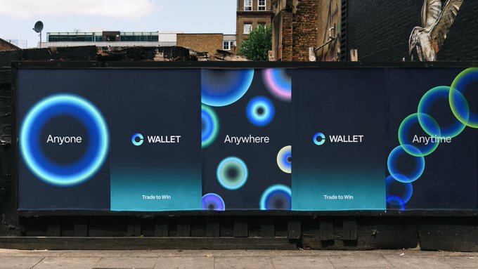 A billboard advertisement for "C Wallet" displays the slogan "Trade to Win" alongside the phrases "Anyone," "Anywhere," and "Anytime" on dark panels featuring colorful circular designs, reflecting the tagline "No permission needed. Trade everything onchain."