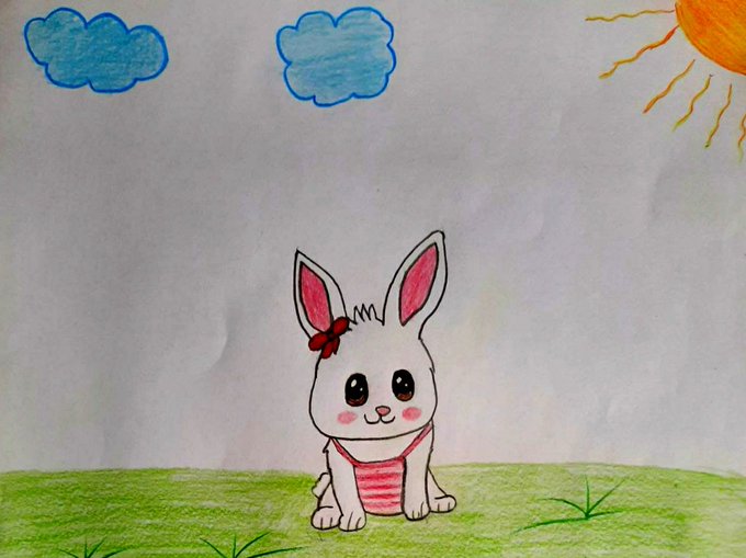 A child's drawing of a cute white bunny wearing a pink-striped outfit and a red bow, sitting on green grass under a sun and clouds.