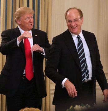 Two men in suits laughing together, with the man on the left giving a thumbs up; the man on the right resembles David Rockefeller.