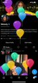 A very dark and blurry screenshot of what appears to be a mobile application interface, possibly a photo or design app, featuring colorful balloon-like graphics.