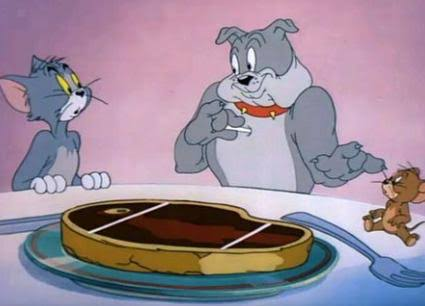 A scene from the Tom and Jerry cartoon showing Tom the cat and Spike the dog looking at a steak on a plate, with Jerry the mouse nearby.