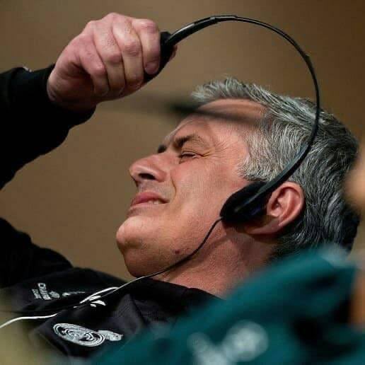 A trader wearing a headset with his eyes closed and hand clenched in apparent frustration or exhaustion, captioned with the radio phrase "'just bridged to base cha..'" referencing a failed communication—likely illustrating the moment a trader receives bad market news or a connection failure on the trading floor.