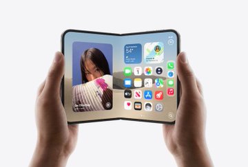 Hands holding a foldable smartphone opened to reveal an inner display with widgets, weather information, and app icons.