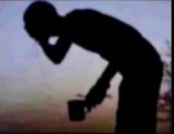 A dark silhouette of a person leaning forward, holding a mug in one hand while appearing to speak on a phone, is shown against a softly lit pastel sky background. The hunched, weary posture of the figure visually echoes the post's sentiment about reluctantly going to work to afford a luxury car like a Mercedes-Benz.