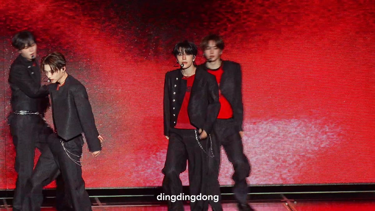 The image features a group of four young men dressed in black suits, standing next to each other against a red background. The photo has been edited with a watermark that reads "dingdingong" at the bottom right corner. This suggests that the image might have been used for promotional purposes or as part of an online marketing campaign related to the Korean pop group YouTubers.