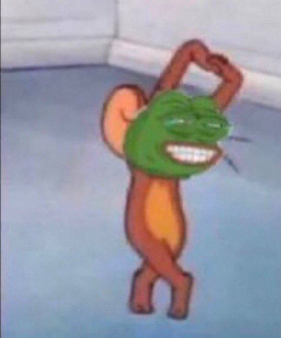 A blurry image shows a cartoon character with a green frog-like head and orange body standing on a blue floor with arms raised.