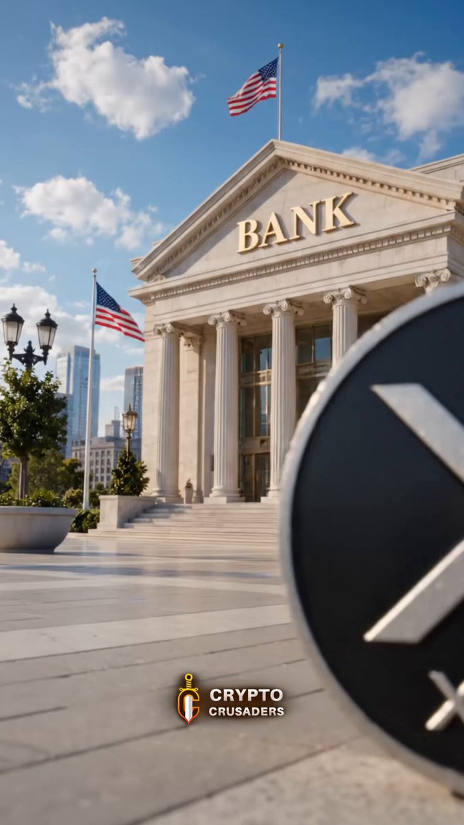 The image shows a bank building with an American flag flying above its entrance, indicating that the bank is located in the United States. The text in the image suggests that banks are now allowed to buy and sell digital tokens called Ripple, which can be used as a form of payment or investment. This change allows banks to participate in the cryptocurrency market and potentially earn profits from buying and selling Ripple tokens.
