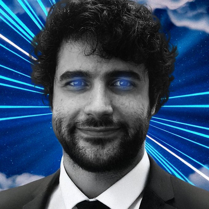 An artistic portrait of a bearded man in a suit with glowing blue eyes and bright blue light rays radiating outward against a sky background.