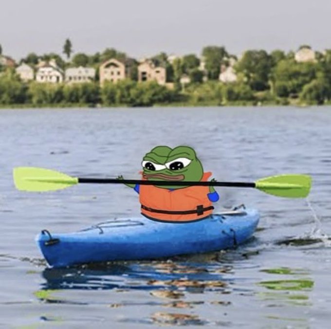 The image shows Pepe the Frog, the popular internet meme character, paddling a blue kayak on a calm river while wearing an orange life jacket, with houses and trees visible in the background. The scene fits the "good morning" post by depicting a cheerful, ready-to-take-on-the-day vibe as Pepe embarks on an early morning kayaking adventure.