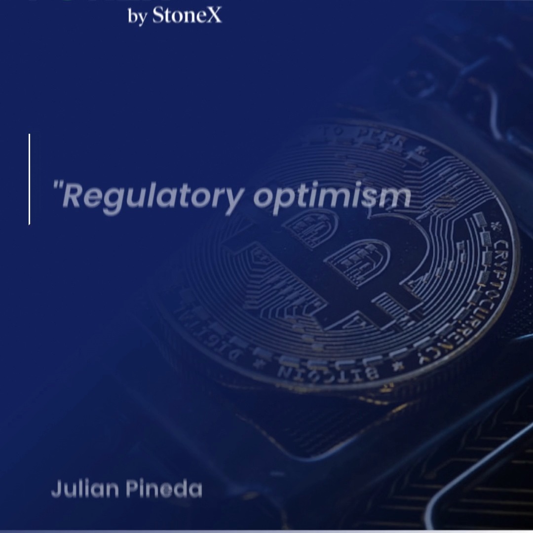 A promotional graphic from StoneX featuring a Bitcoin coin on a dark blue background, with the title "Regulatory optimism" prominently displayed in white text alongside author Julian Pineda, highlighting how regulatory developments are shaping current crypto market sentiment.