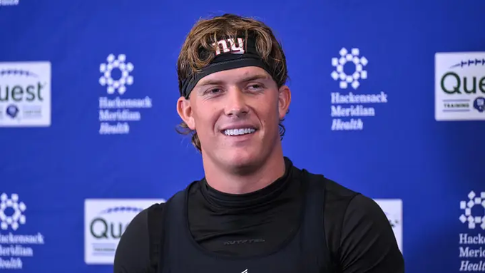 In the image, a man wearing a black shirt with a New York Giants logo is smiling at the camera while standing against a blue backdrop featuring logos for Quest and Hackensack Meridian Health. The text "NY Giants QB Jaxson Dart" suggests that he might be a professional football player or athlete associated with the Giants team. The phrase "The retarded Bitcoin soft fork BIP-110 has already lost." implies that there is some sort of controversy or negative perception surrounding Bitcoin, which could potentially affect the man's image as an athlete and his association with the Giants team.

Overall, the image captures a moment where the man is smiling for the camera while standing in front of logos related to Quest and Hackensack Meridian Health, possibly indicating that he is involved in or associated with these organizations.