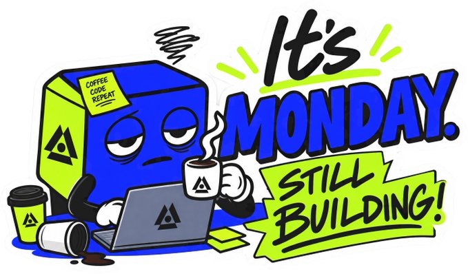 A grumpy, tired-looking blue cube character sips coffee while working on a laptop, accompanied by the bold text "IT'S MONDAY. STILL BUILDING!" and a sticky note labeled "COFFEE CODE REPEAT." The image captures the weary but determined Monday morning grind often associated with the "GM" (Good Morning) greeting to the Shardians crypto community.