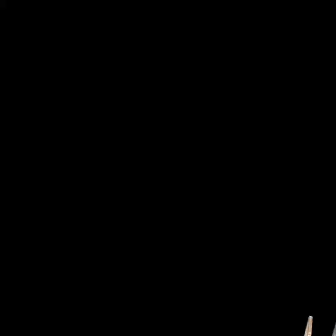 The image features a black background with white text that reads "组牌挑战赛·本周开局！ 总奖池突破 205,000 USDT 皇家同花顺专属大奖", which is a description of an event. The image also includes a small wooden object in the bottom right corner and a watermark that reads "Bybit App" at the bottom left corner.