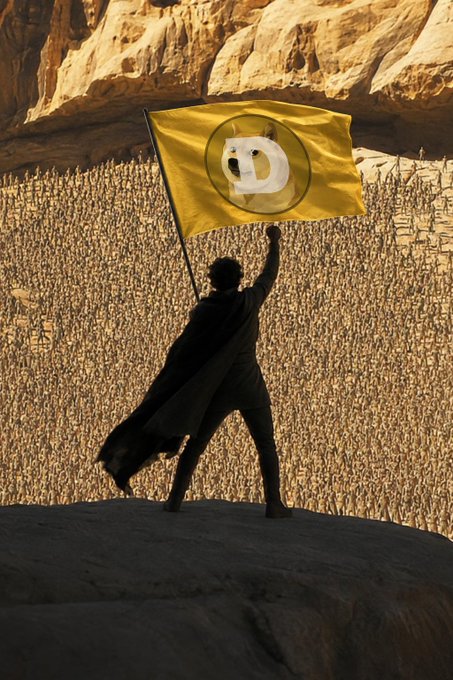 A silhouetted figure in a flowing cape stands triumphantly atop a rock formation, raising a yellow flag bearing a white stylized logo in front of a massive terraced amphitheater carved into sandstone cliffs.