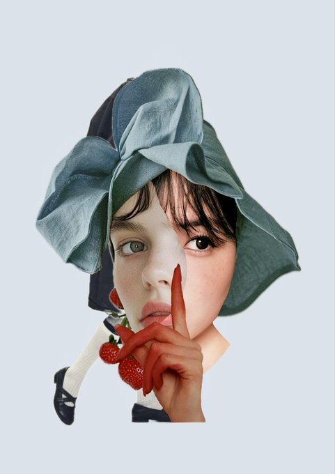 Artistic portrait of a person with short dark hair wearing an oversized blue fabric headpiece, holding a finger to their lips while posing with strawberries.