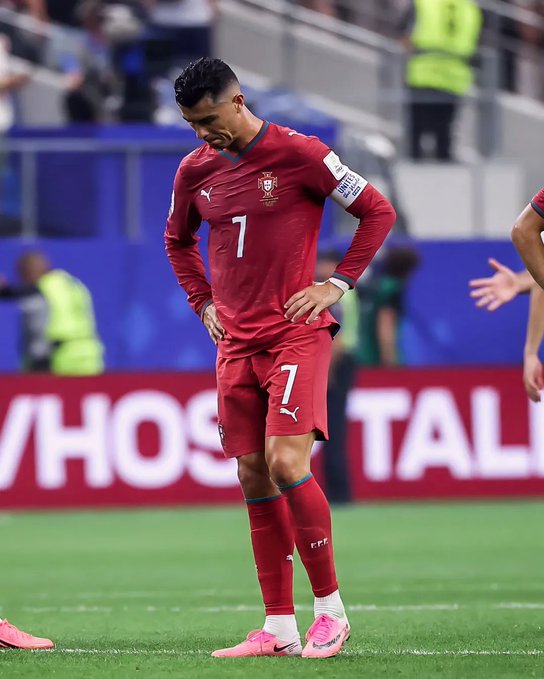 A soccer player wearing a red Portugal national team jersey with the number 7 stands with his head bowed on the pitch, evoking a somber moment that aligns with the post's melancholic tribute to a veteran player likely appearing in his final World Cup. The Puma logo and "FFP" text are visible on his kit as he reflects in what appears to be an emotionally heavy farewell scene.