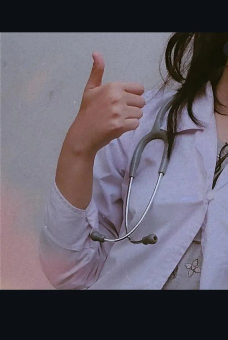 A close-up shot shows a person in a white coat giving a thumbs-up gesture, with a stethoscope draped around their neck.