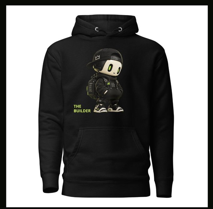 A black hoodie displays a cartoonish robot character wearing a backward cap, jacket, and backpack, accompanied by the yellow text "THE BUILDER," promoting the first Stackbots NFT merch where 50% of profits fund the NFT vault.