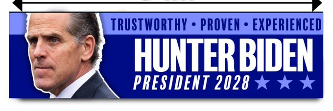 The image features a blue sign with an illustration of a man's face, likely representing a political figure or leader. The text on the sign reads "Hunter Biden President 2028", indicating that this is a campaign for Hunter Biden as a presidential candidate. The sign also includes three stars, which could be part of a logo or symbol associated with the campaign.