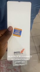 A hand holds a white box labeled 'metro MOBILITY PROGRAM D.D. INTERNATIONAL AIRPORT' with a blue Mastercard logo sticker.