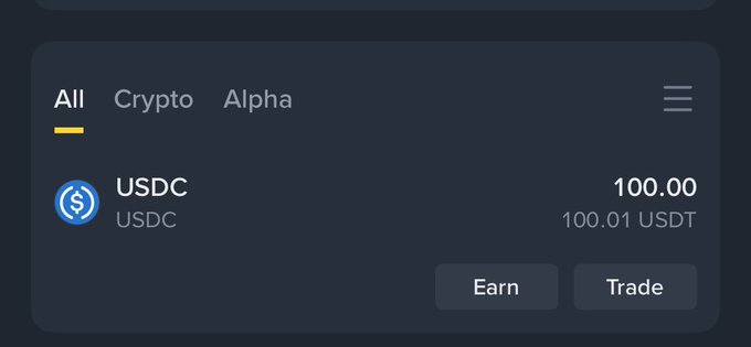 Crypto wallet balance display showing 100.00 USDC (≈100.01 USDT) with 'Earn' and 'Trade' action buttons.