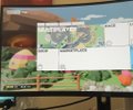 A blurry indoor scene showing what appears to be a projected presentation or display screen mounted in a room.
