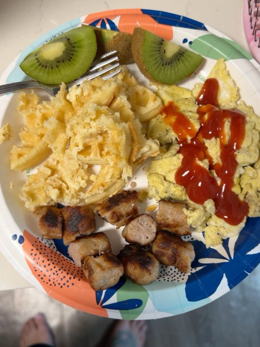 A colorful paper plate holds a hearty breakfast of scrambled eggs topped with ketchup, sausage links, hash browns, and kiwi slices, ready to fuel a day of crypto commentary.

The post's "pumpfun" reference to crypto gains pairs humorously with the image's "pump" of calories and ketchup — a tongue-in-cheek nod to fueling up for the bull run ahead.