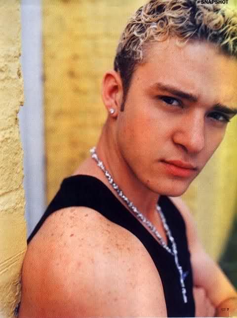 The image shows a young man with curly blonde hair wearing a black tank top and a silver chain necklace, with a small "#SNAPSHOT" watermark visible in the upper right corner—though the photo doesn't appear to actually display any Avalanche Summit merchandise, making the "leaked merch" claim questionable. The accompanying text seems to be a promotional post attempting to sell merchandise that isn't shown in the image.