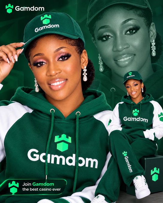 A promotional advertisement for 'Gamdom' featuring a smiling woman wearing a green and white Gamdom cap and hoodie, with the tagline 'Join Gamdom the best casino ever' at the bottom.