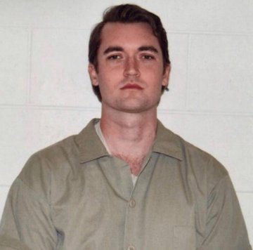 A mugshot of Ross Ulbricht, the creator of Silk Road, shown wearing a tan collared shirt against a white tiled background. The image visually identifies him as the central figure referenced in the post about how his Silk Road marketplace helped establish Bitcoin's real-world use case.