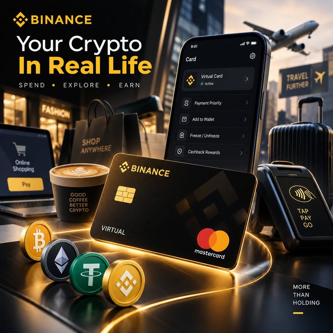 A Binance promotional image titled 'Your Crypto In Real Life' featuring a virtual Mastercard, a phone displaying the Binance Card app, a coffee cup labeled 'GOOD COFFEE BETTER CRYPTO', cryptocurrency coins, a laptop, shopping bag, and luggage.