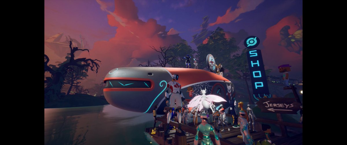 The image features a large airplane with people standing around it. The airplane has a red nose and white body, giving it an interesting appearance. There are several people gathered near the airplane, some of them wearing team jerseys. A sign can be seen in the background that reads "Team Canada Grab your kit @FIFAWorldCup". Another sign is visible on the right side of the image, which says "Best-looking kit, imo" and provides a price for the items displayed.
