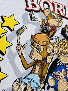 Close-up of a graphic t-shirt featuring stylized cartoon monkeys in streetwear, including a character holding a paint roller, with the word 'BORN' partially visible.