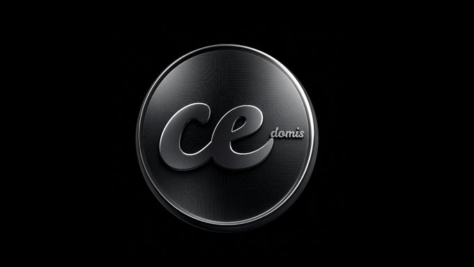 A glossy black circular logo with the text 'ce domis' in silver lettering is displayed against a black background.