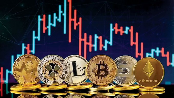 A row of physical cryptocurrency coins including Monero, XRP, Litecoin, Bitcoin, Dash, and Ethereum displayed in front of a digital candlestick price chart.
