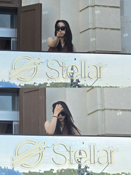 The image features a woman with long hair wearing sunglasses standing next to a building, possibly at an event or gathering. The photo captures her from two different angles, showing her from above and below. In both instances, she appears to be enjoying herself and is surrounded by people who seem to be having a good time as well.