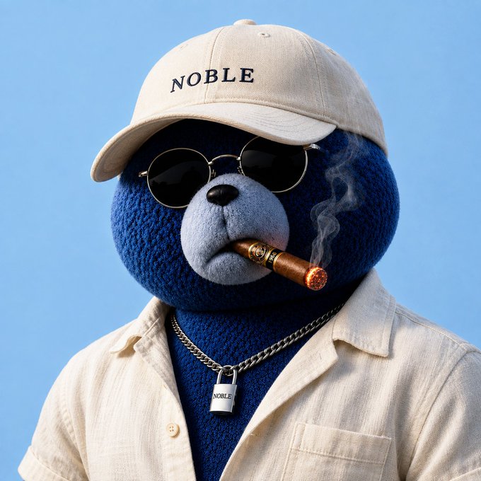 A blue teddy bear wearing a "NOBLE" baseball cap, round sunglasses, and a chain necklace with a "NOBLE" padlock pendant smokes a cigar while dressed in a cream-colored shirt against a blue sky background.