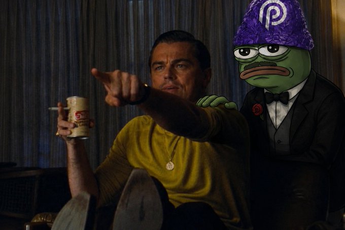 The image features two men sitting next to each other with one man pointing towards something while the other man wears a funny hat, possibly a frog or a character from a cartoon. The scene takes place indoors, likely in a living room setting. A cup is visible on a surface nearby, and there are chairs around them.

The post includes text that reads "My bro, the developer has just realised that Pyth Pro @PythNetwork added new commodity futures feeds Me: Cocoa, Coffee, Raw Sugar and Live Cattle". This suggests that the men might be discussing recent developments in the agricultural market or a specific product related to these commodities.