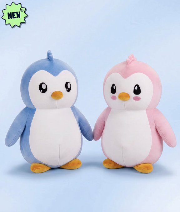 Two adorable Pudgy Penguins plushies—one blue and one pink with blushing cheeks—stand side by side holding hands, with a green "NEW" badge displayed in the upper left corner to highlight their fresh release.