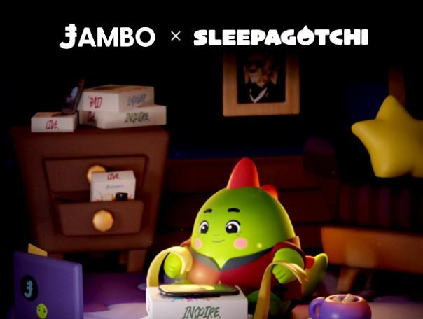A collaboration announcement image showing "JAMBO × SLEEPAGOTCHI" at the top, featuring a green dinosaur-like Sleepagotchi character sitting next to a box labeled "INSPIRE" with additional boxes and a star pillow in a cozy bedroom setting, illustrating the post's point about the partnership extending beyond just an app into real-world daily use.