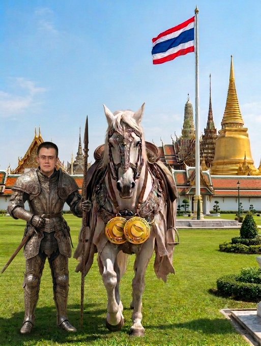 A man in ornate silver armor stands next to a heavily decorated white horse in front of the Grand Palace in Bangkok, with the Thai national flag waving above them against a backdrop of golden stupas.