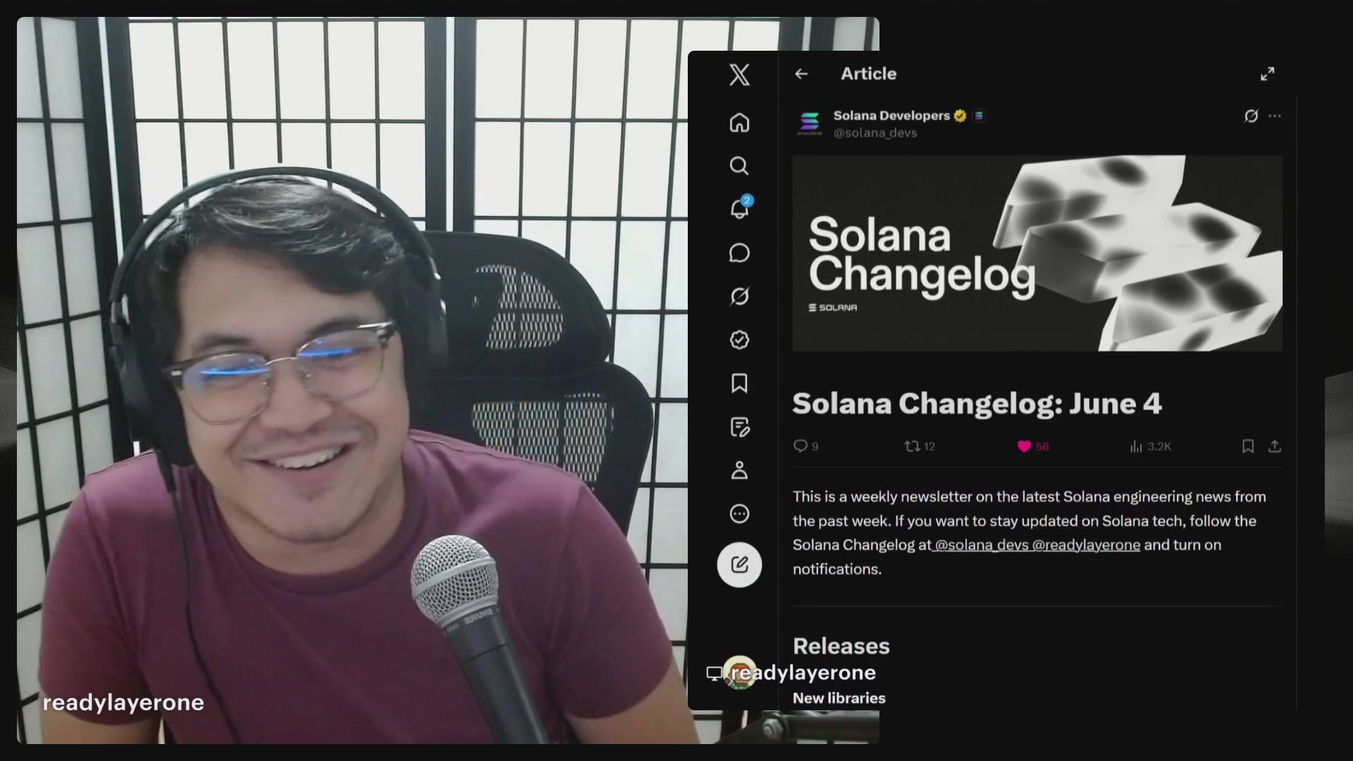 The image shows a man wearing glasses sitting behind a microphone, smiling at the camera while holding a microphone. He appears to be participating in an online live show or event related to the "Solana Changelog Live Show". The background of the image is blurred and does not provide any additional information about the context of the scene.