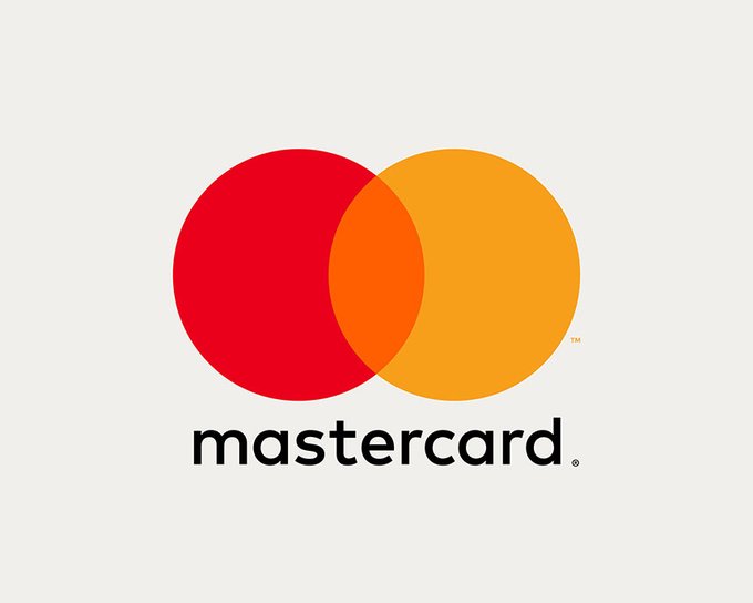 The image features a logo of the Mastercard company displayed against a white background. The logo consists of two red circles with an orange center, representing the Mastercard brand name. Below the logo, there are several lines of text that provide information about the partnership between Mastercard and various payment processing companies. These partnerships include Aave, Coinbase, OKX, Polygon, Ripple, and Solana.