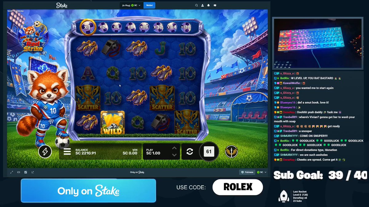 The image shows a slot machine game with a red panda character standing next to a keyboard. The game has a blue background and features various symbols such as a soccer ball, trophy, and sports ball. The text "Only on Stakes" is displayed in the bottom left corner of the screen, indicating that this is a slot machine game available for purchase only at the Red Strike casino.