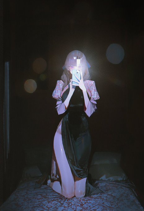 A figure with long dark hair kneels on a bed in a dimly lit room, holding a glowing phone that illuminates their face and a black dress with floral sleeves, visually echoing the post's warning about falling for an OTC scam by being deceived through impersonation on messaging platforms.