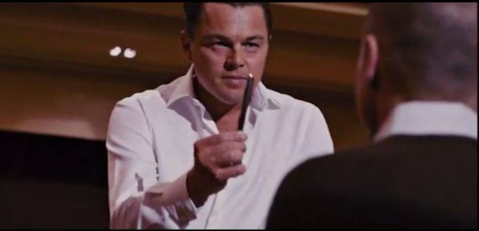 The image shows a man wearing a white shirt, holding a pen up to his face as if pointing at someone or something. The caption below the image reads "shill us some alpha [ ticker ] [ thesis ]". This suggests that there might be an ongoing discussion or negotiation related to a specific topic in the context of the post.

The man's position and actions indicate that he is actively involved in the conversation, possibly presenting his viewpoint or defending his stance on a particular subject. The caption serves as a call-to-action for viewers to engage with the content by sharing their thoughts or opinions about the topic being discussed.